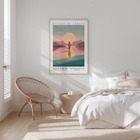 a bedroom with a bed, a woven chair, and a framed poster on the wall.