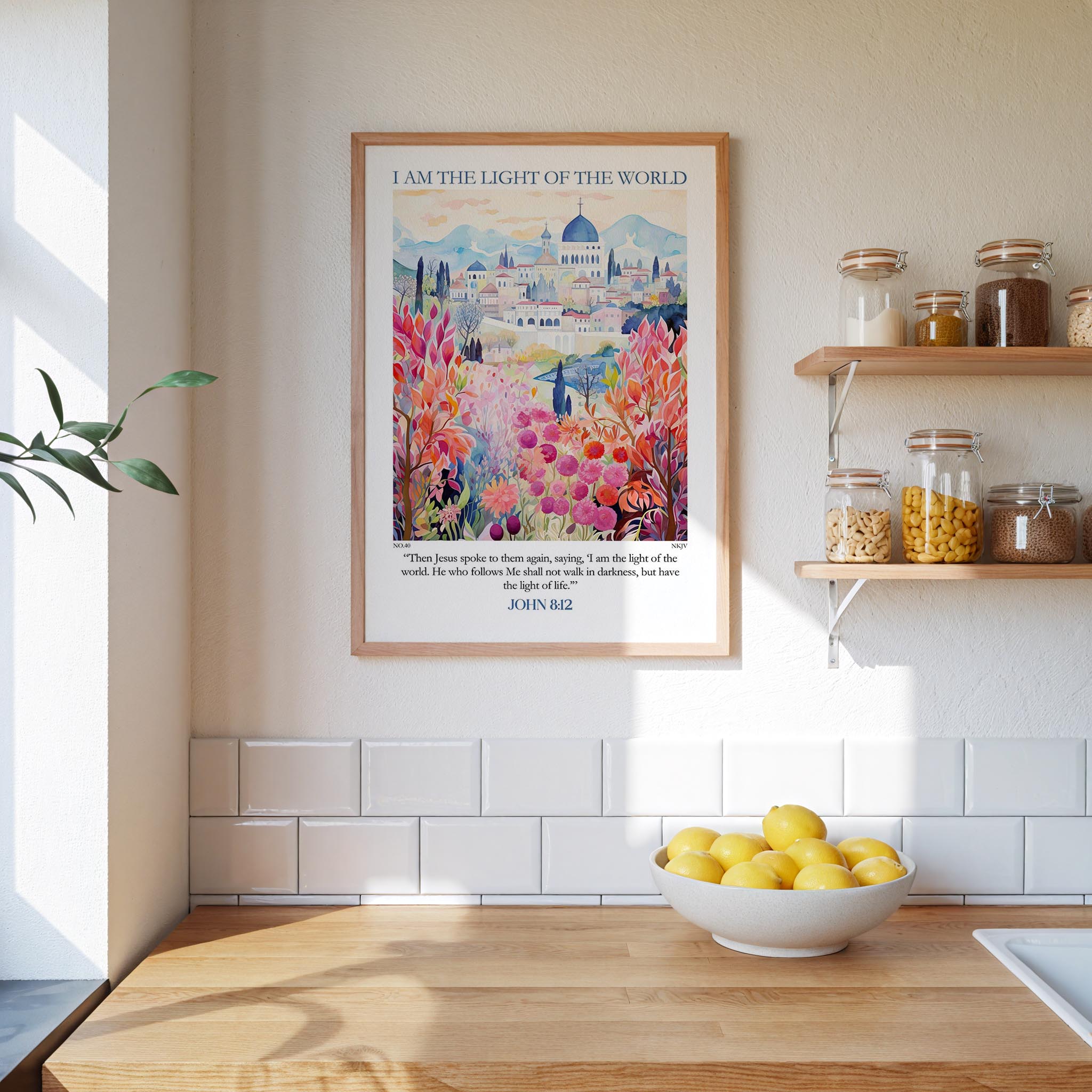 a kitchen scene with a framed poster of a colorful garden hanging on the wall above a wooden countertop with a bowl of lemons.