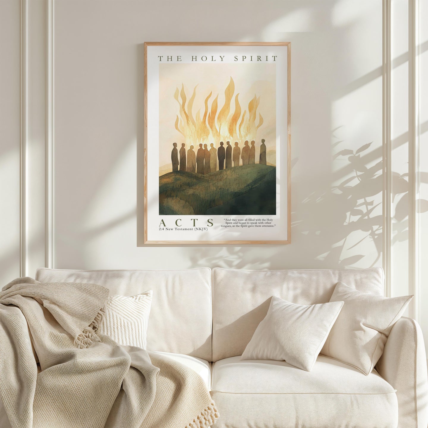 a framed poster of a group of people standing on a hill with flames in the background, hanging on a wall above a white couch.