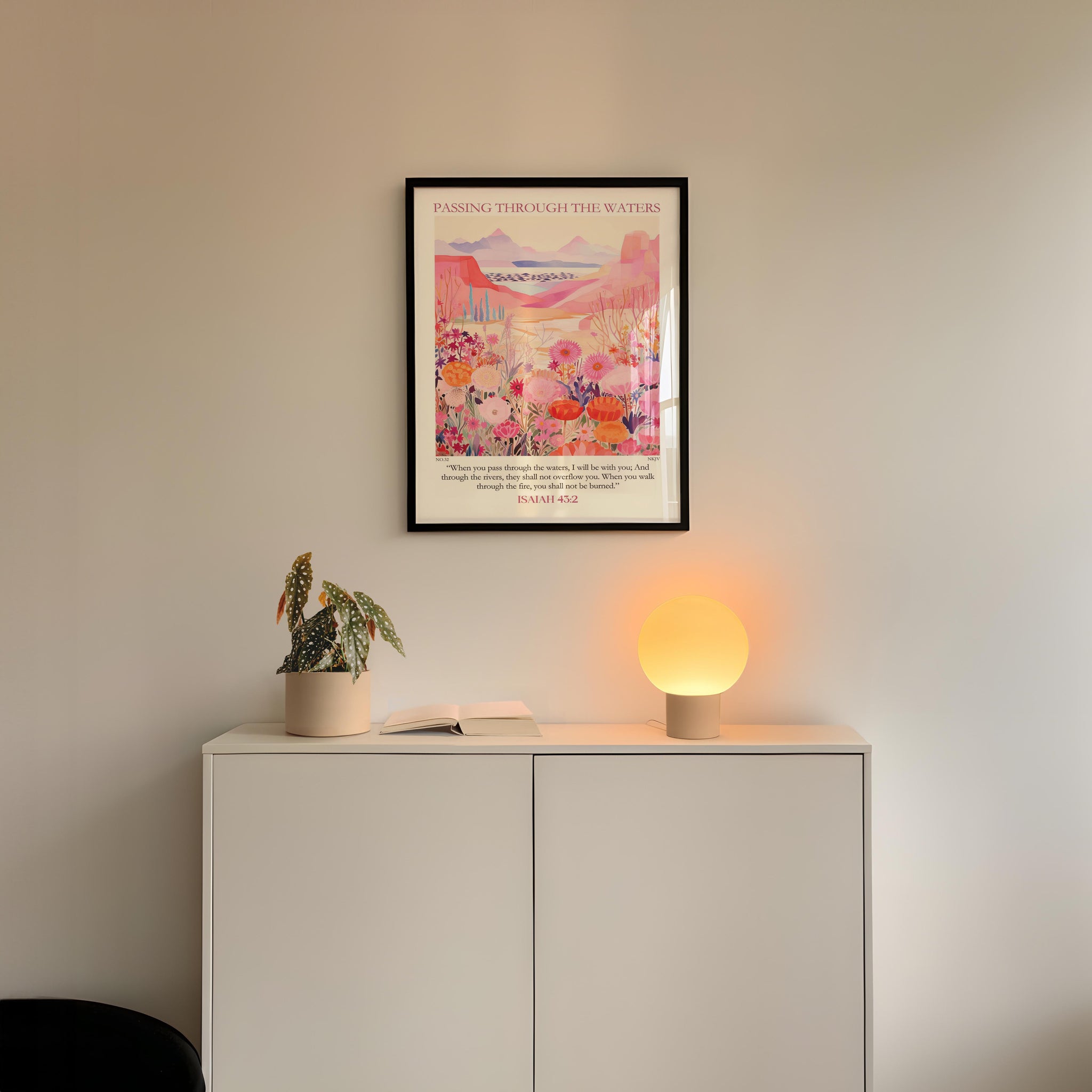 a white cabinet with a potted plant and a lamp on top, set against a white wall.