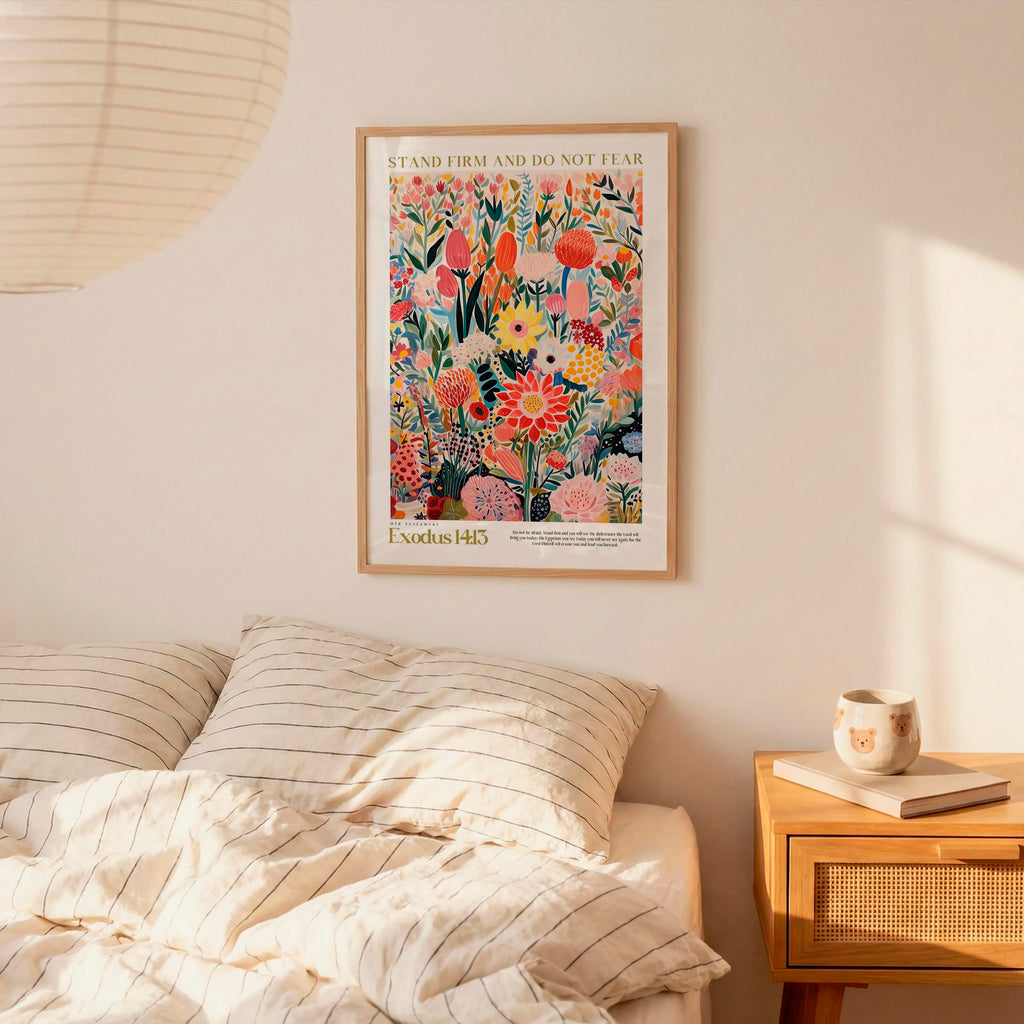 a bedroom scene with a bed, a nightstand, and a framed poster of a colorful floral design hanging on the wall above the bed.
