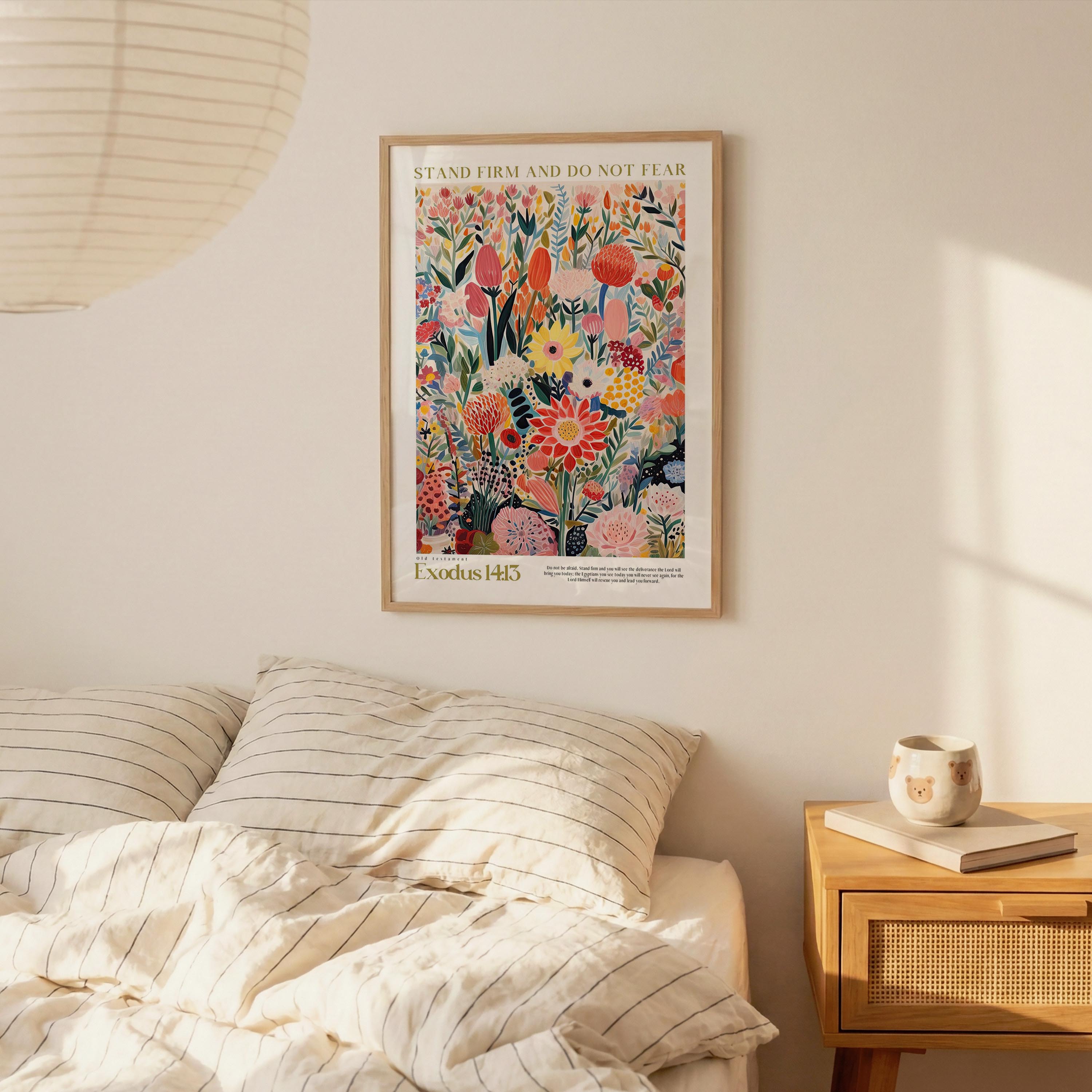 a bedroom scene with a bed, a nightstand, and a framed poster of a colorful floral design hanging on the wall above the bed.