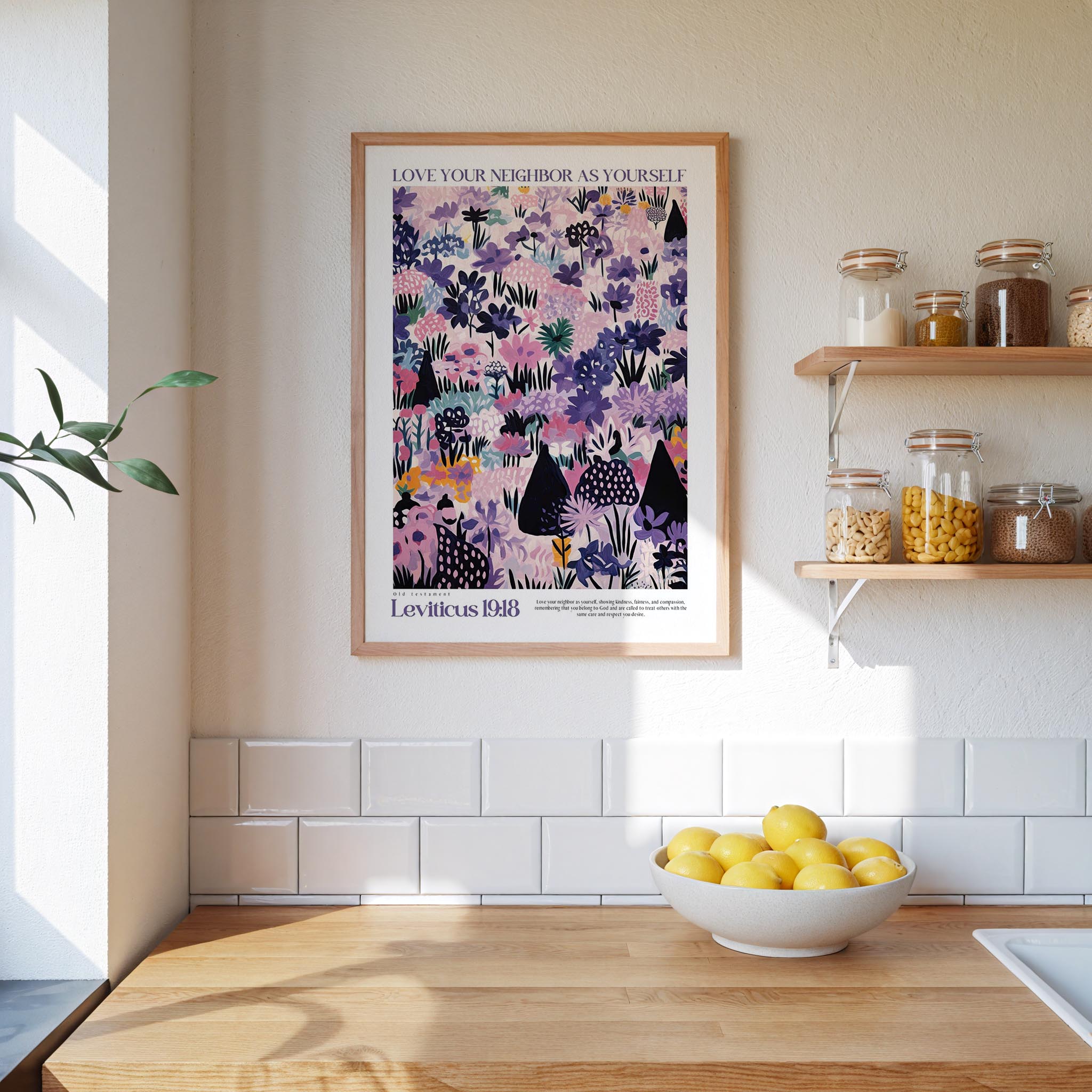 a kitchen scene with a framed poster of a colorful floral pattern hanging on the wall above a wooden countertop with a bowl of lemons.