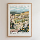 The image is a framed poster depicting a pastoral scene with a stone wall, flowers, and mountains in the background. The text on the poster reads "THE LORD IS GOOD" and "PSALM 34: 34-Old Testament ( NKJV )".
