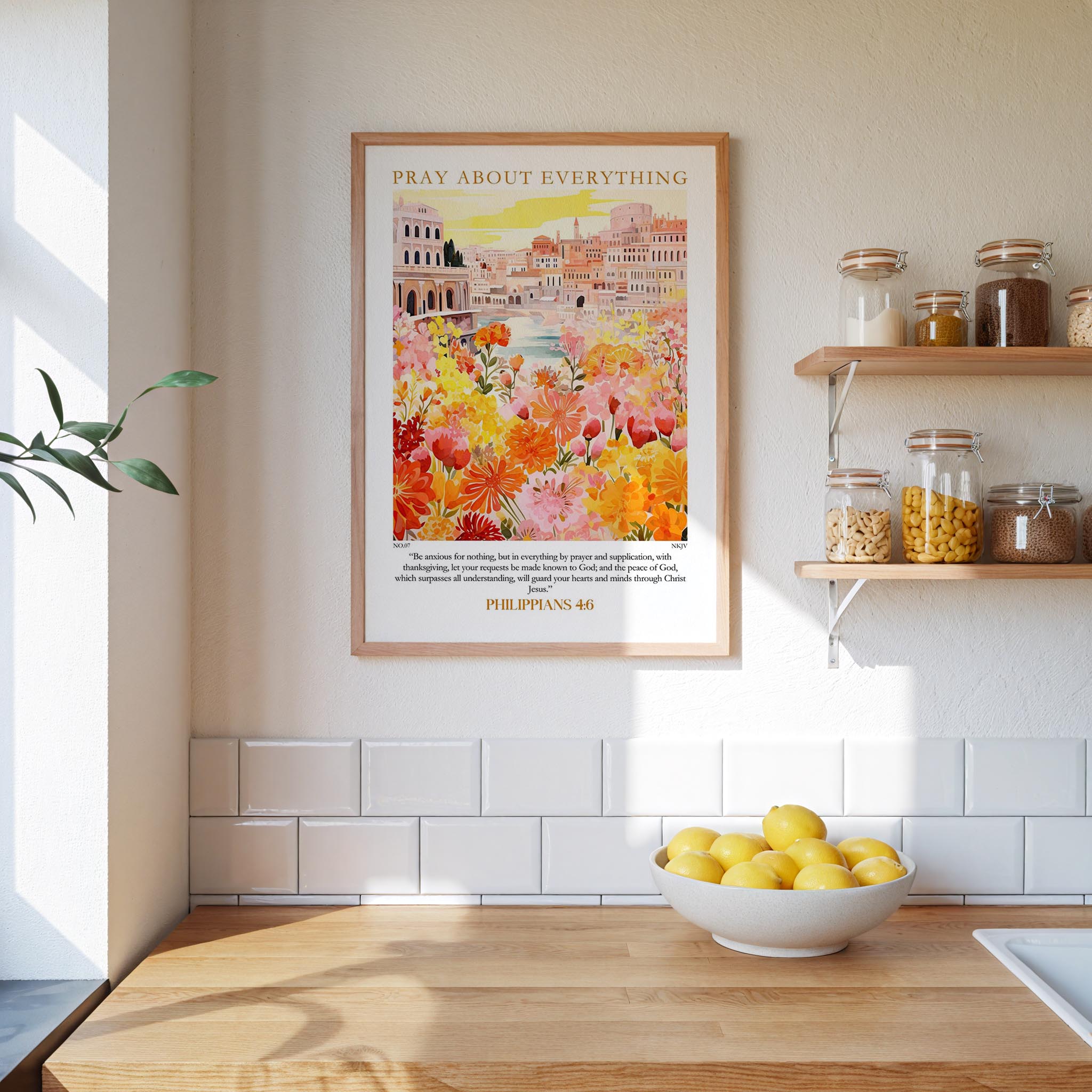 a kitchen scene with a framed poster of a colorful garden hanging on the wall above a wooden countertop with a bowl of lemons.