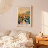 a poster of a large crowd of people, with a religious or historical theme, hanging on a wall above a bed with striped bedding.