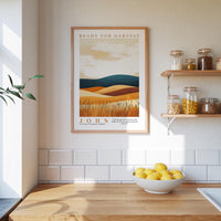 a kitchen scene with a framed poster of a desert landscape hanging on the wall above a wooden countertop with a bowl of lemons.