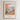 The image is a framed poster depicting a colorful illustration of a cityscape with a fruit tree in the foreground.