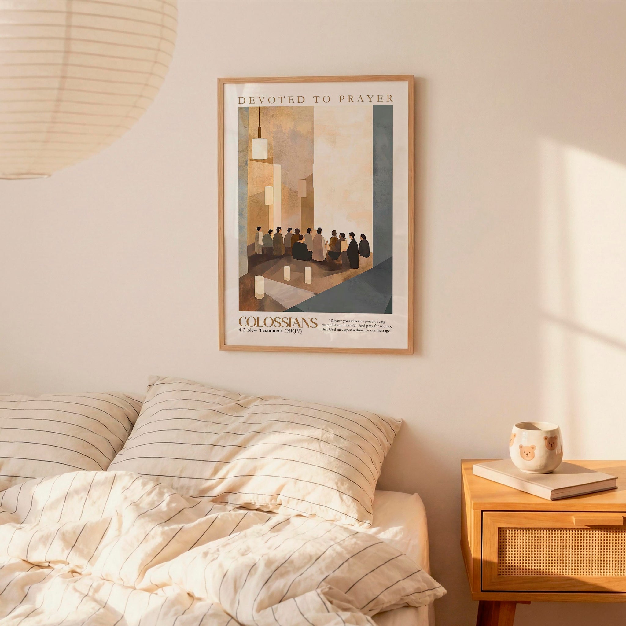 a bedroom setting with a framed poster of a group of people on the wall above a bed with striped bedding.