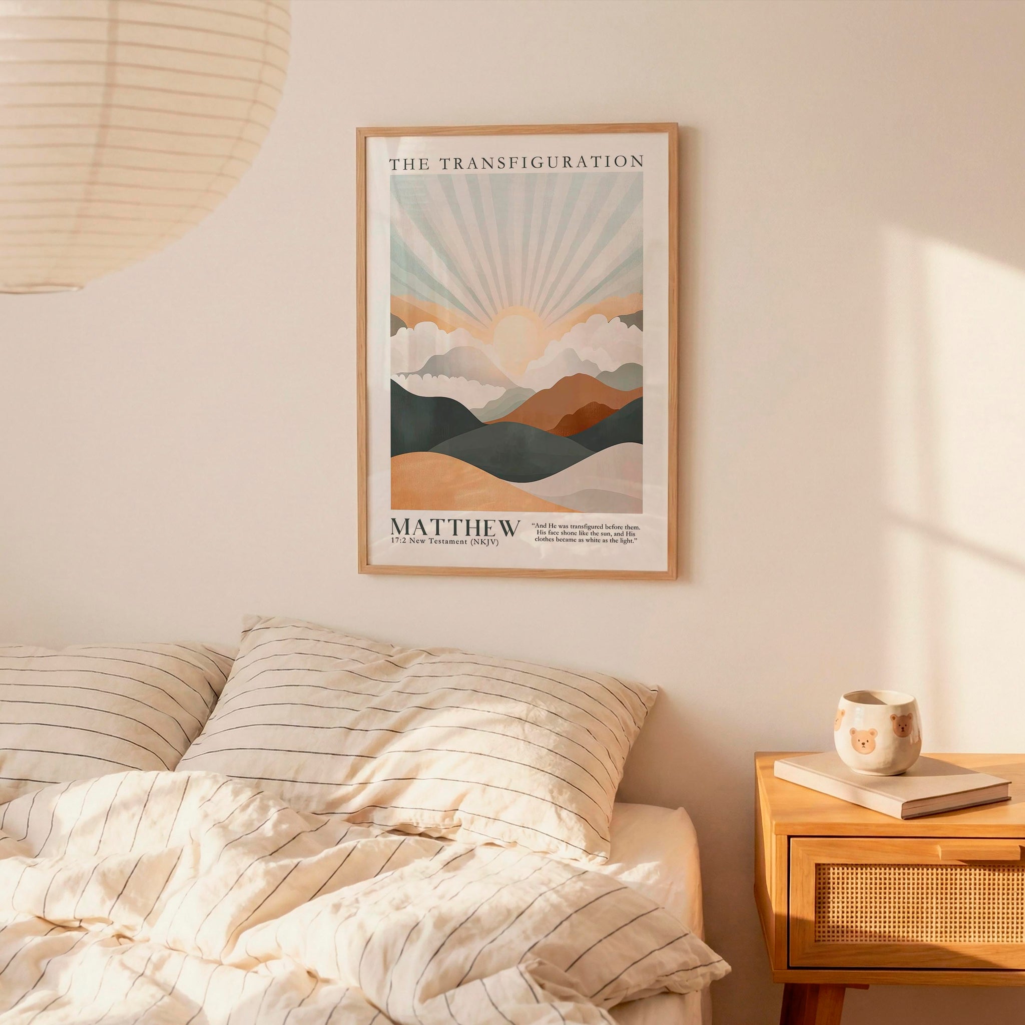 a bedroom scene with a framed poster of a mountain landscape hanging on the wall above a bed with striped bedding.