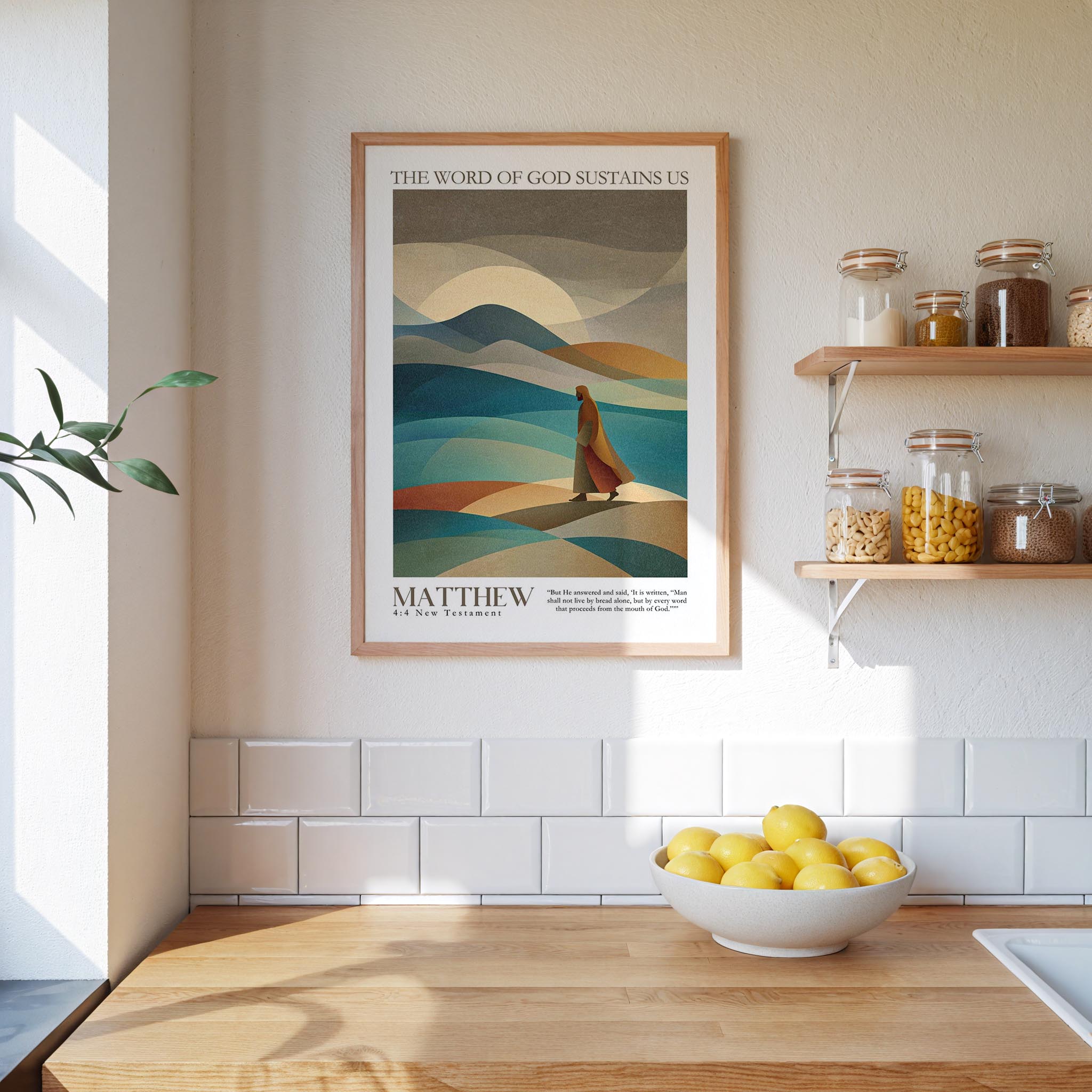 a framed poster of a person walking on a beach, with mountains in the background, hanging on a wall above a wooden countertop with a bowl of lemons.