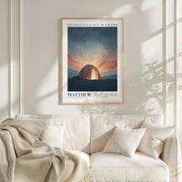 a framed poster of a sunset over a desert landscape, with the text "DEATH COULD NOT HOLD HIM" and "MATTHEW" below the image.