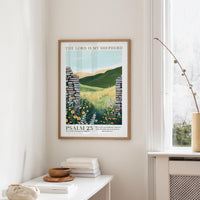 a framed poster of a pastoral landscape with a stone wall and flowers, hanging on a wall next to a window.