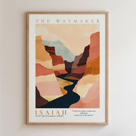 The image is a framed poster featuring an abstract landscape with mountains and a winding river. The poster is titled "The Waymaker" and includes a biblical verse from Isaiah 43:19, which reads "I even make a road in the wilderness and rivers in the desert."