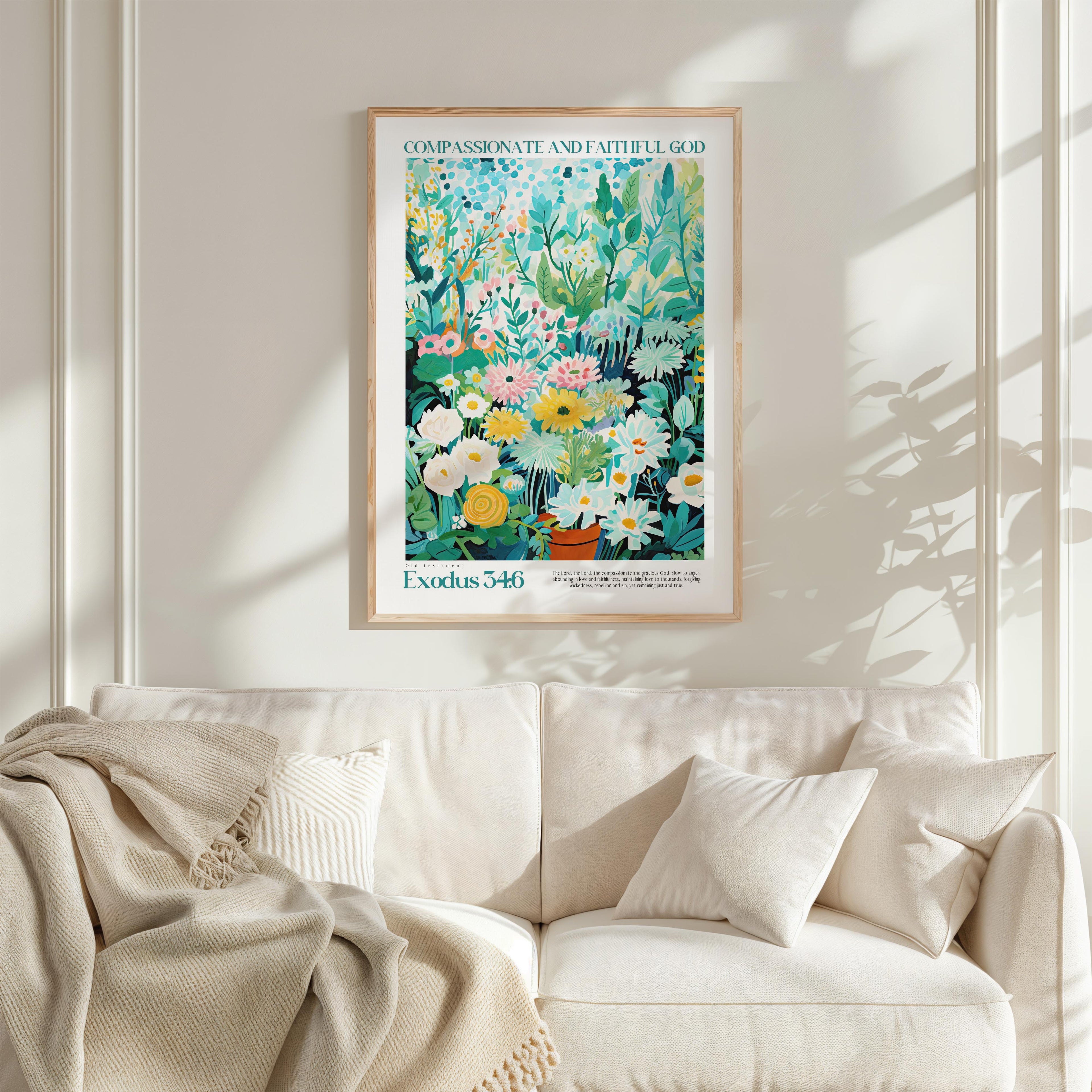 a framed poster of a colorful floral arrangement hanging on a white wall above a white couch with a blanket draped over it.