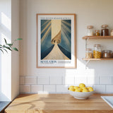 a kitchen counter with a bowl of lemons, a framed poster of a spiral staircase, and a shelf with jars and containers.