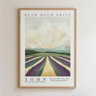 The image is a framed poster featuring a landscape with a field of purple flowers and a mountain range in the background. The poster has a vintage style and is framed in a wooden frame.