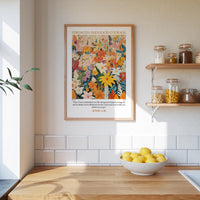 a kitchen scene with a framed poster of a colorful floral design hanging on the wall above a wooden countertop with a bowl of lemons.