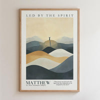 The image is a framed poster featuring a mountain landscape with a silhouette of a person standing on a peak. The poster includes a quote from the New Testament about Matthew, and the text is in a modern, minimalist style.
