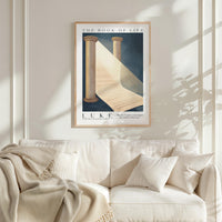 a framed poster of a book of life hanging on a wall above a white couch with a blanket draped over it.