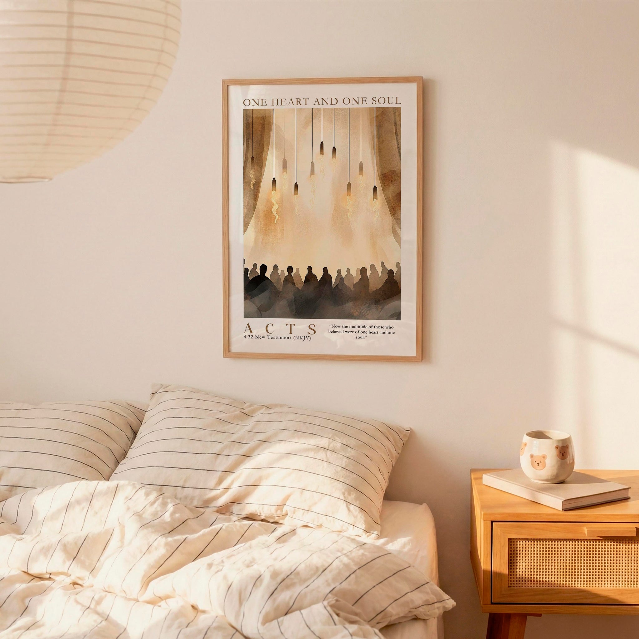 a bedroom setting with a framed poster of a group of people hanging on the wall above a bed with striped bedding.