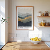 a kitchen counter with a bowl of lemons, a framed poster of mountains, and a shelf with jars and containers.