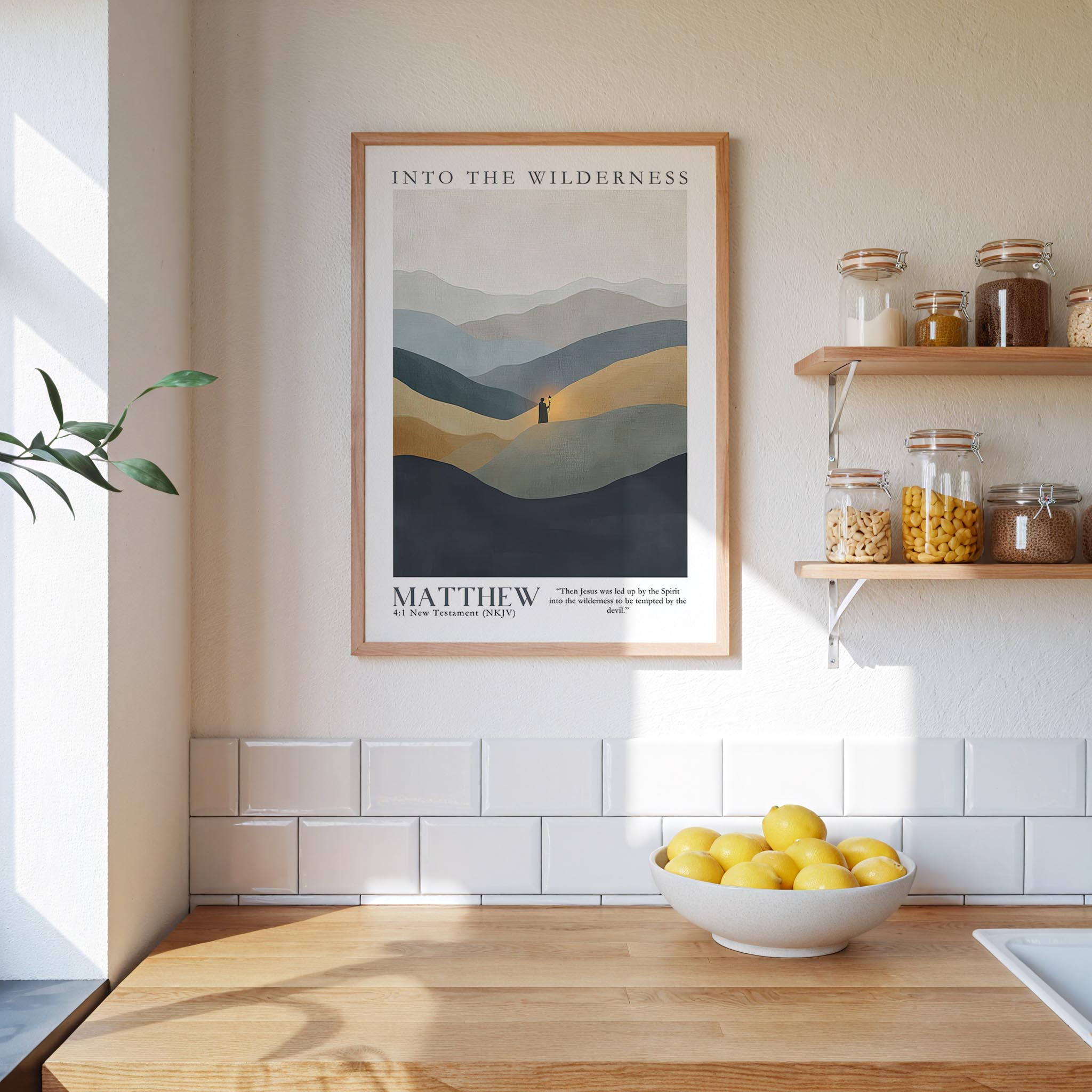 a kitchen counter with a bowl of lemons, a framed poster of mountains, and a shelf with jars and containers.