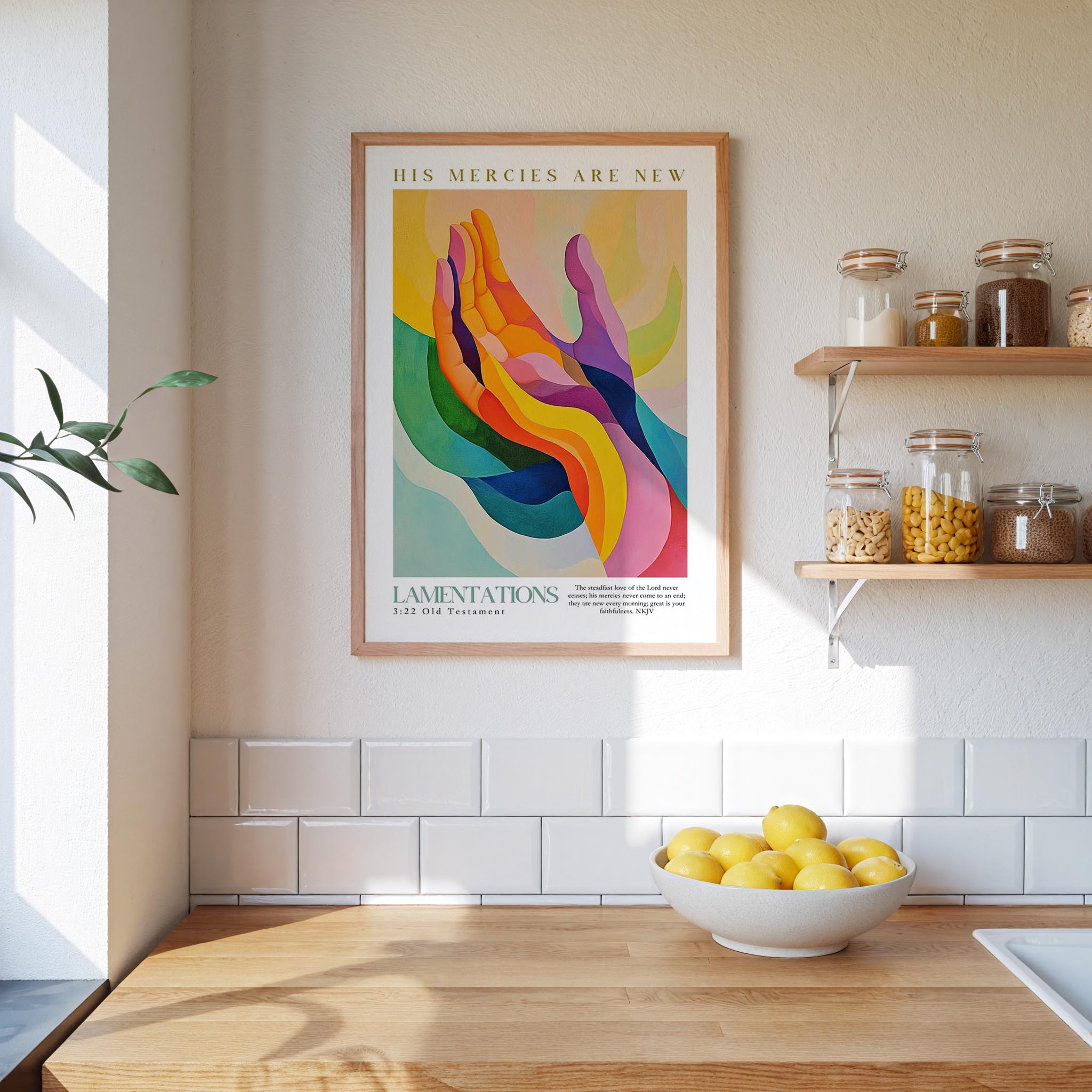 a kitchen counter with a bowl of lemons, a framed poster of abstract hands, and a shelf with various jars and containers.