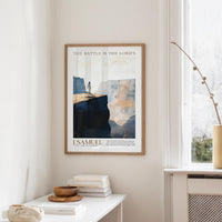 a framed poster of a person standing on a cliff, with the text "The battle is the LORD's" above the image.