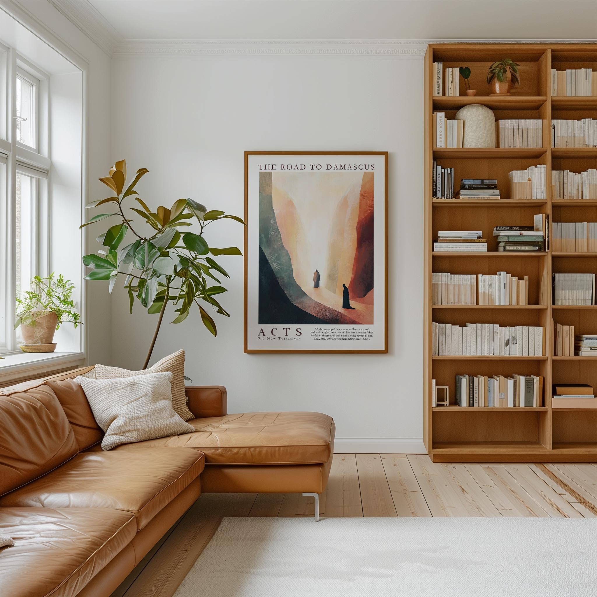 a cozy living room with a large bookshelf filled with books, a comfortable leather sofa, and a large framed poster on the wall.