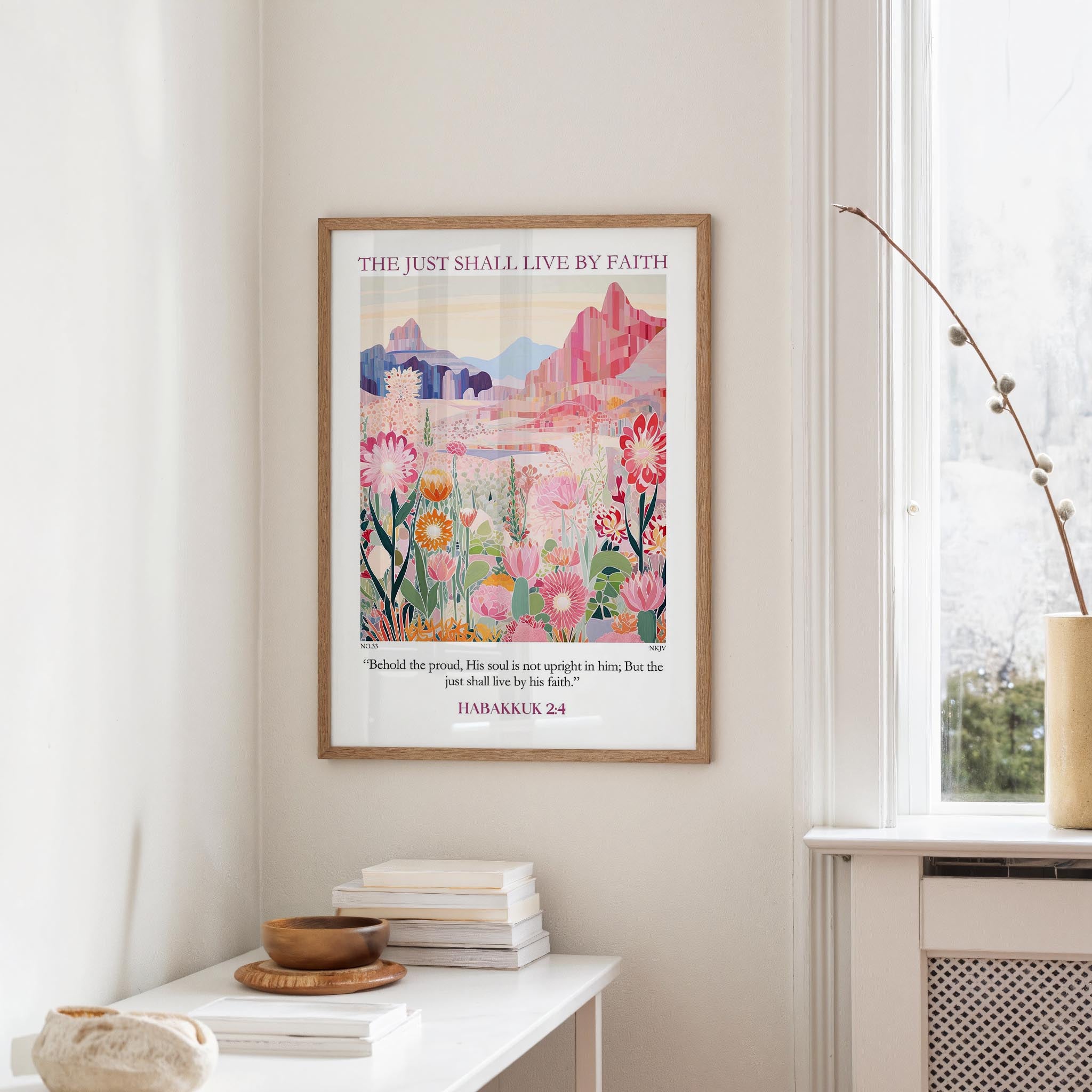 a framed poster of a colorful floral landscape hanging on a wall, with a quote from the Bible referencing the just shall live by faith.