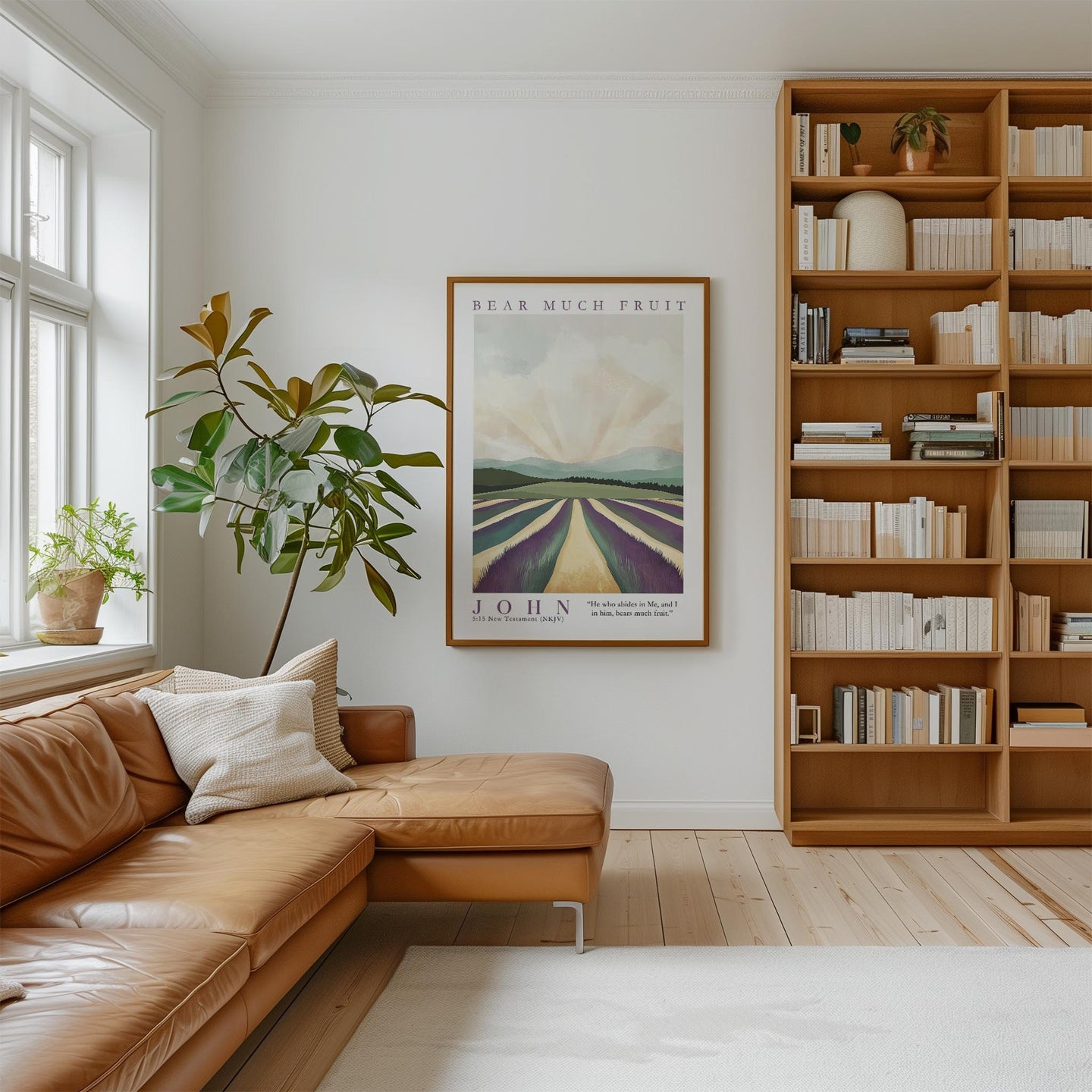 a cozy living room with a large bookshelf filled with books, a comfortable leather couch, and a framed poster of a field with a tree.
