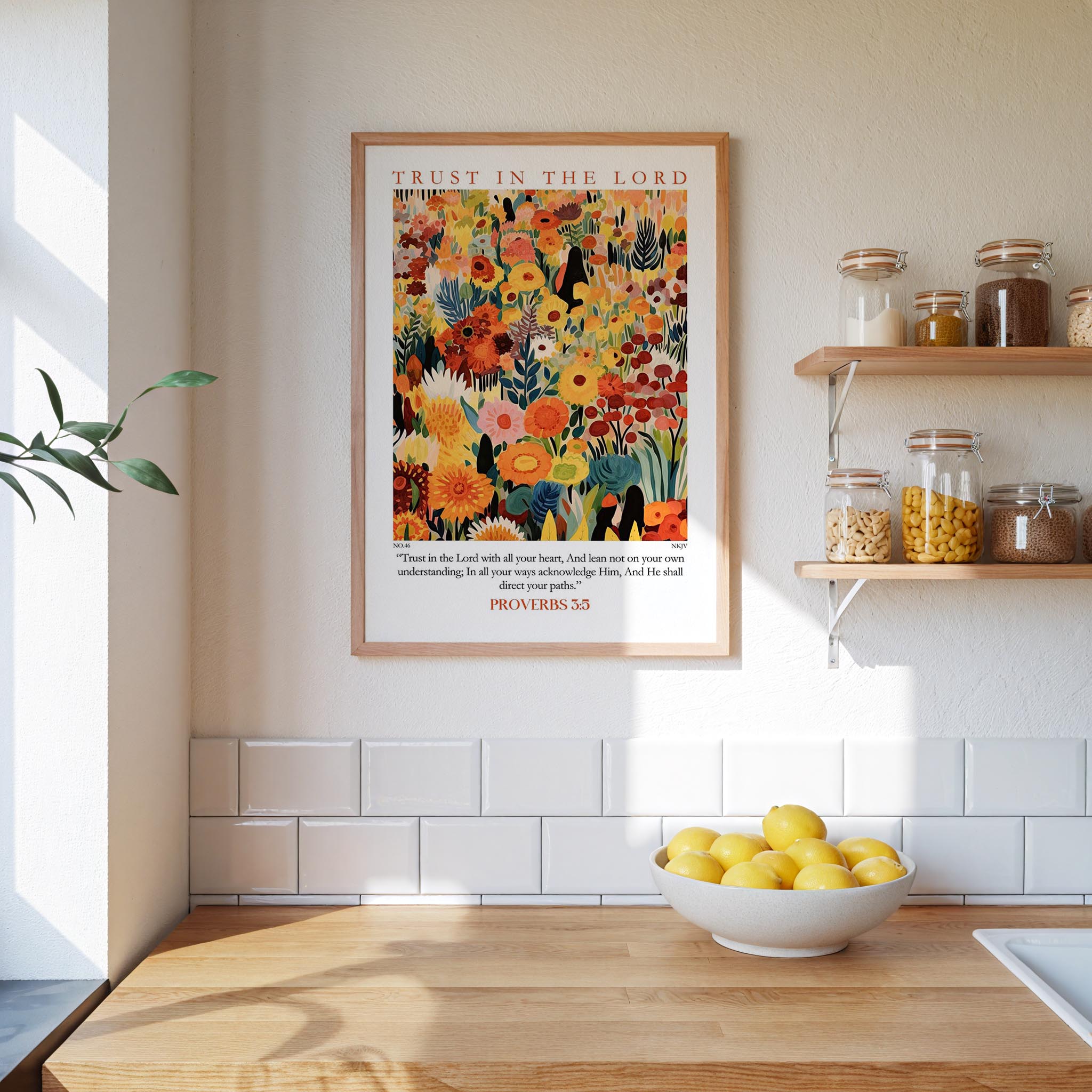 a kitchen scene with a framed poster of a colorful floral design hanging on the wall above a wooden countertop with a bowl of lemons.