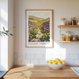 a kitchen scene with a framed poster of a stone path leading through a field of flowers, a bowl of lemons, and shelves with jars and bottles.