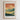 The image is a framed poster with a mountain landscape and a silhouette of a person walking on a path. The poster has a minimalist design with a focus on the mountain and the person walking.