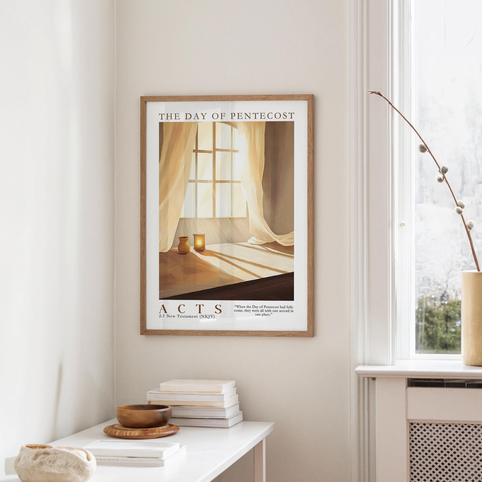 a framed poster of a window with curtains, hanging on a wall in a room with a white table and a vase of flowers.