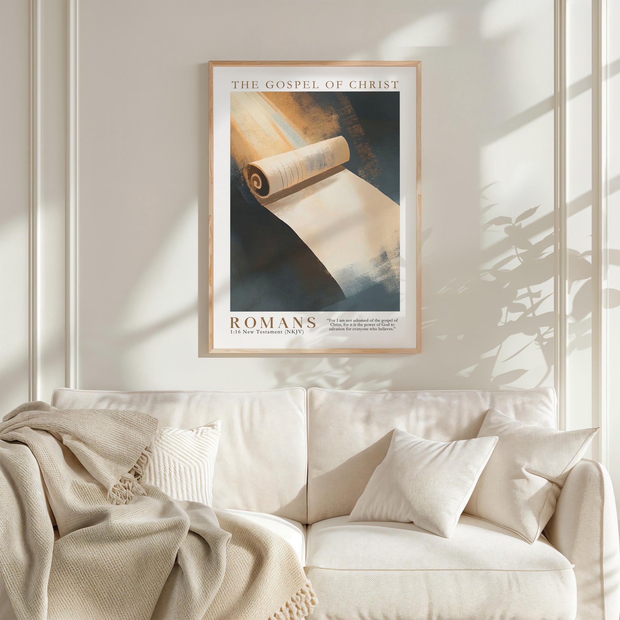 a framed poster of a roll of parchment paper hanging on a white wall above a white couch with a blanket draped over it.