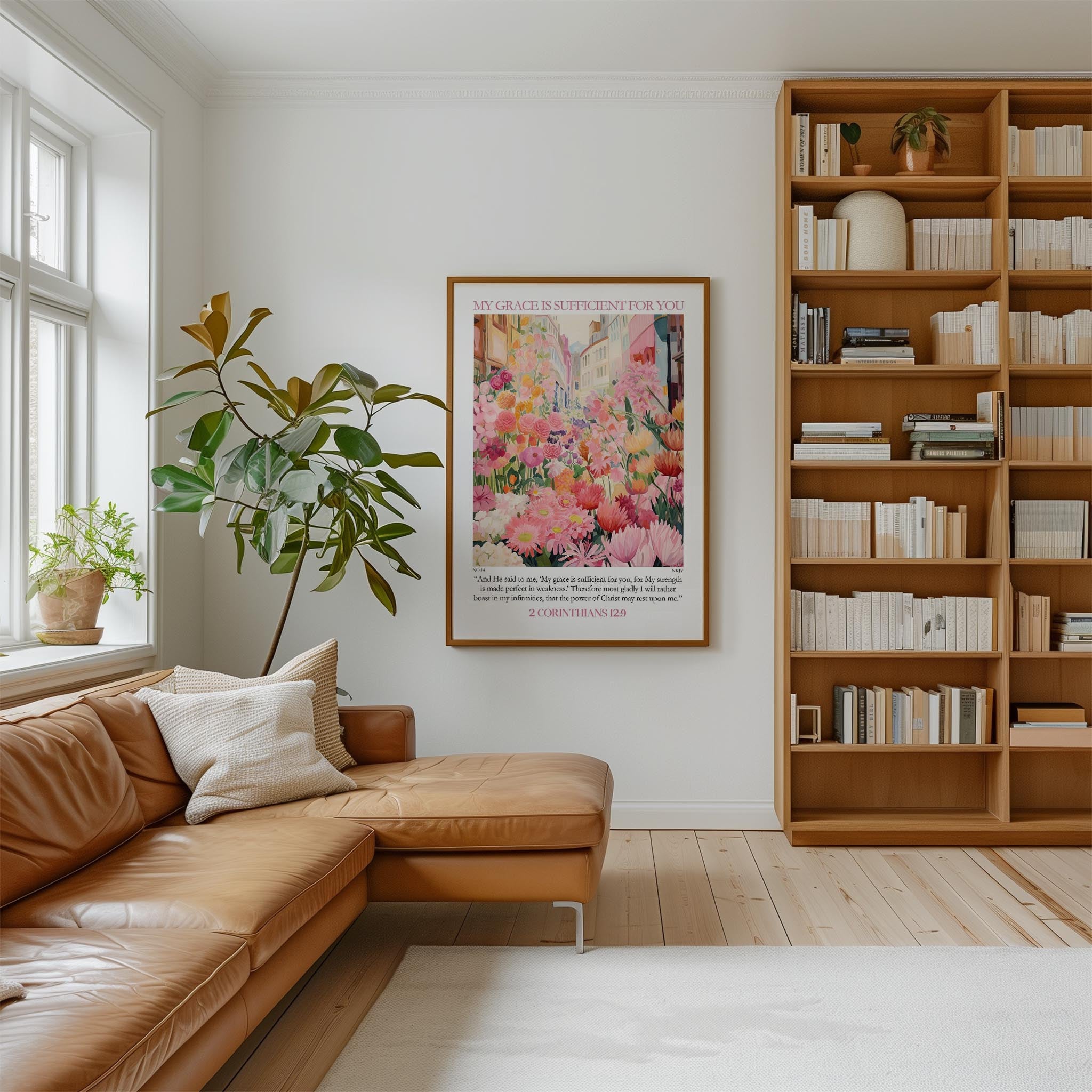 a cozy living room with a large bookshelf filled with books, a comfortable leather couch, and a large framed poster of a colorful floral arrangement hanging on the wall.