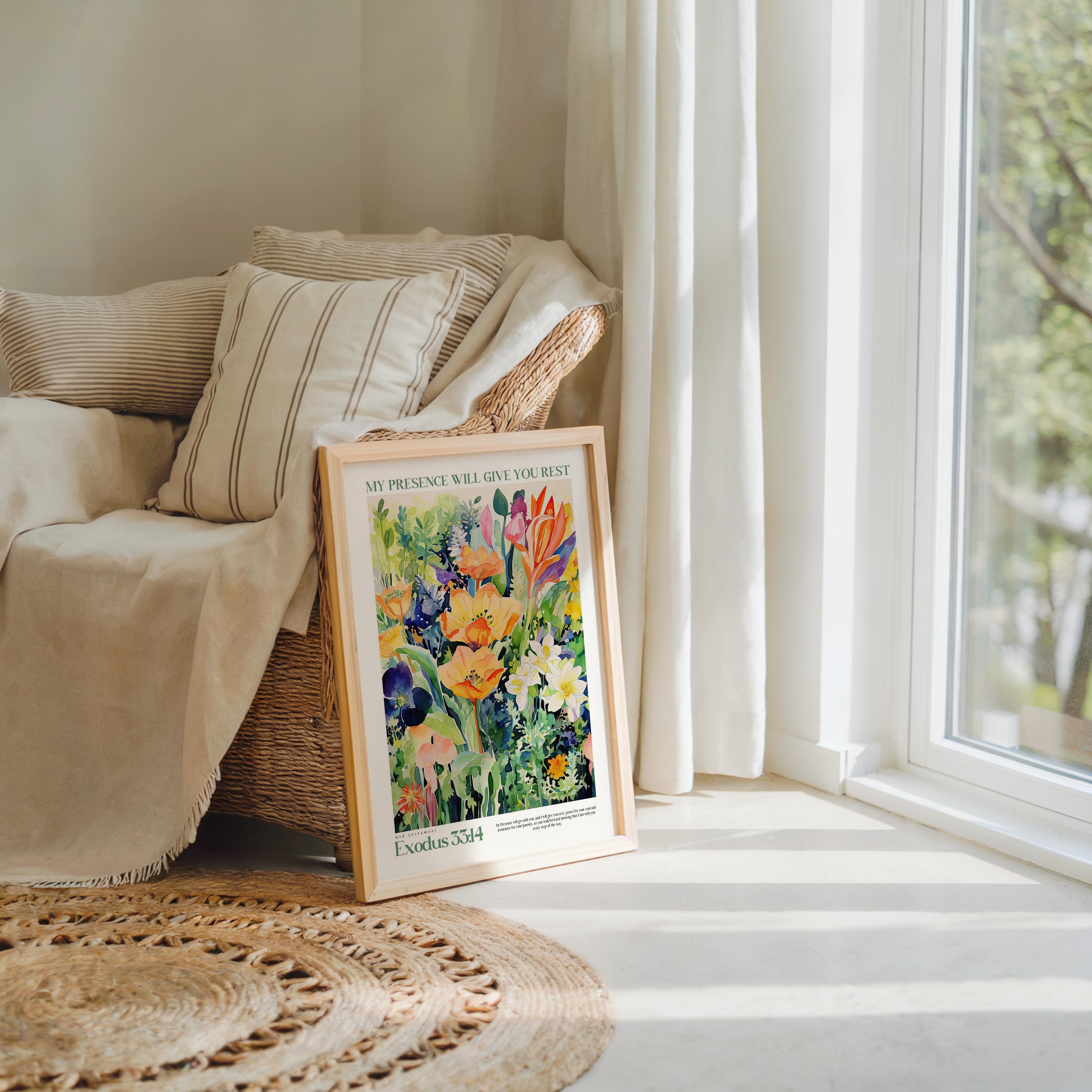 A framed painting of a vibrant garden scene is displayed on a wooden floor next to a window, with a beige sofa and a woven rug in the background.