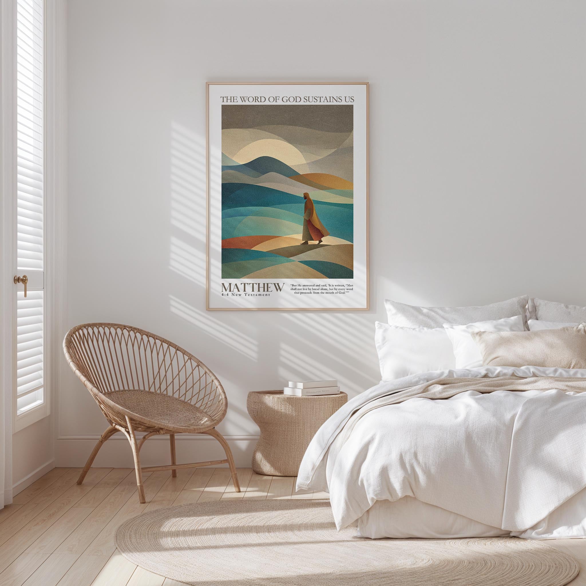 A bedroom with a bed, a woven chair, and a framed poster of a landscape with mountains and a person walking in the distance.